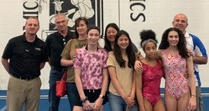 From letf to right: Bryan, Andy Barta, Lori Barta, their daughter, Kathy, her daughter, and two other gymnasts with their coach.